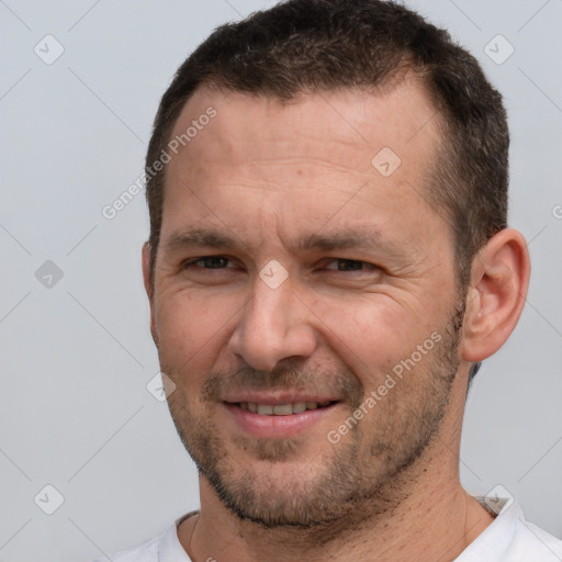 Joyful white adult male with short  brown hair and brown eyes