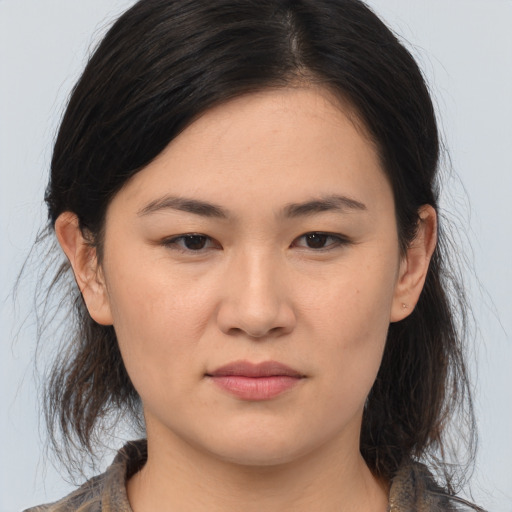 Joyful asian young-adult female with medium  brown hair and brown eyes