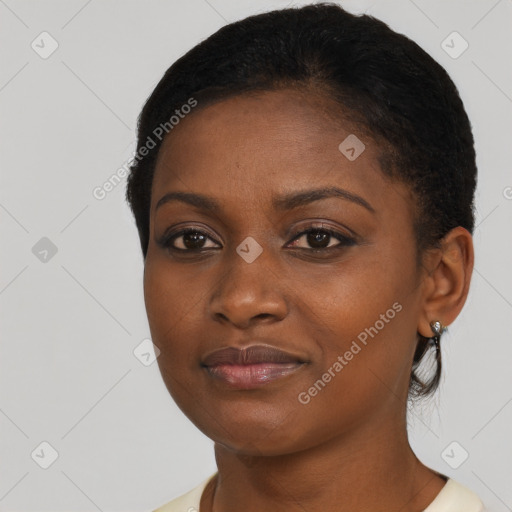 Joyful black young-adult female with short  brown hair and brown eyes