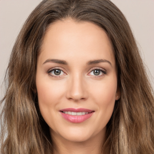 Joyful white young-adult female with long  brown hair and brown eyes