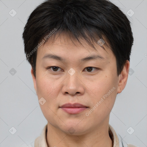 Joyful asian young-adult female with short  brown hair and brown eyes