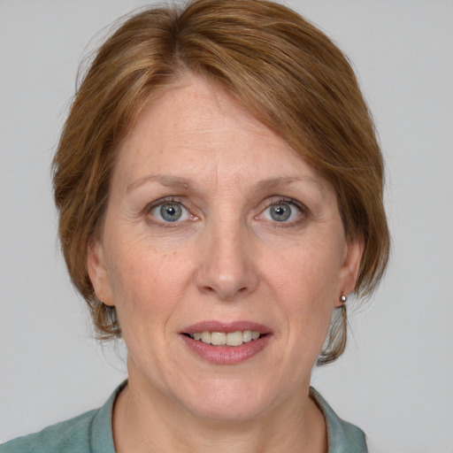 Joyful white adult female with medium  brown hair and blue eyes