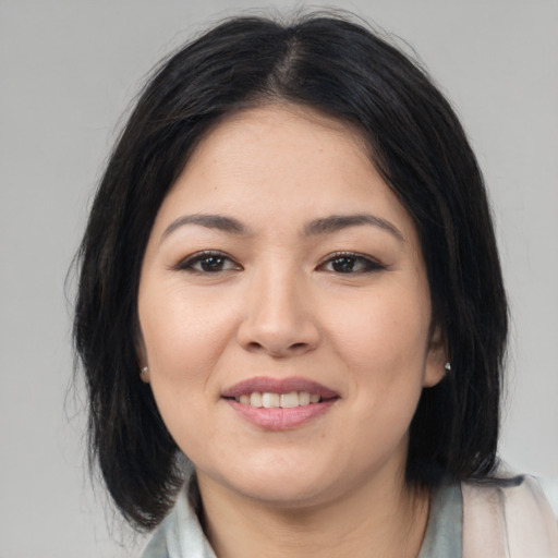 Joyful asian young-adult female with medium  brown hair and brown eyes