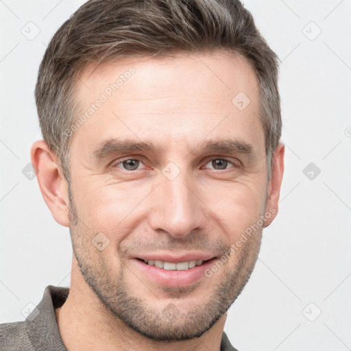 Joyful white adult male with short  brown hair and grey eyes