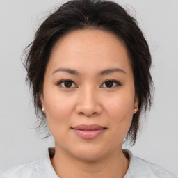 Joyful asian young-adult female with medium  brown hair and brown eyes