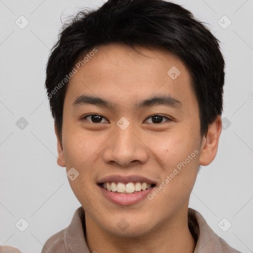 Joyful asian young-adult male with short  brown hair and brown eyes