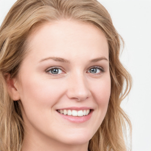 Joyful white young-adult female with long  brown hair and blue eyes