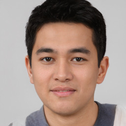 Joyful asian young-adult male with short  black hair and brown eyes