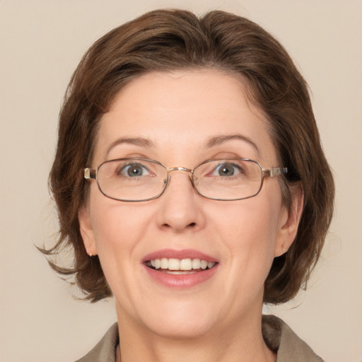 Joyful white adult female with medium  brown hair and grey eyes