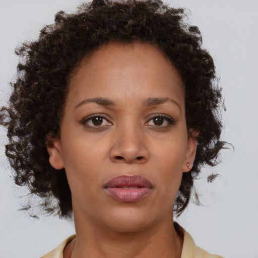Neutral black young-adult female with medium  brown hair and brown eyes