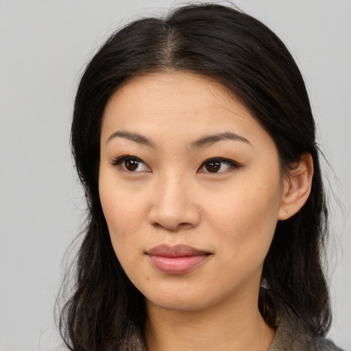 Joyful asian young-adult female with long  brown hair and brown eyes