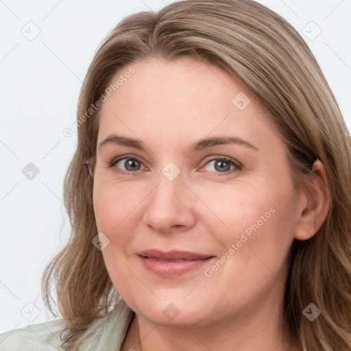 Joyful white young-adult female with long  brown hair and blue eyes