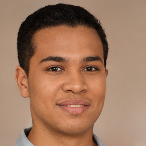 Joyful latino young-adult male with short  brown hair and brown eyes