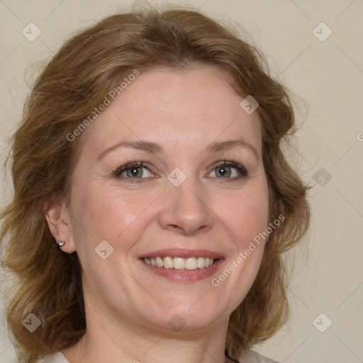 Joyful white adult female with medium  brown hair and blue eyes