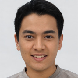 Joyful asian young-adult male with short  black hair and brown eyes