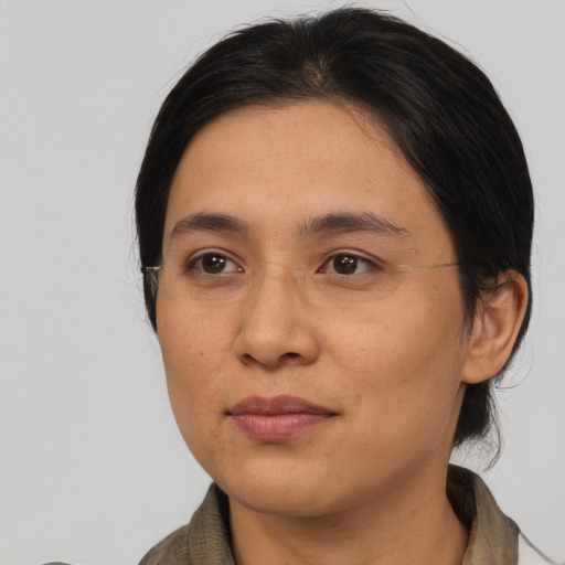Joyful asian young-adult female with medium  brown hair and brown eyes