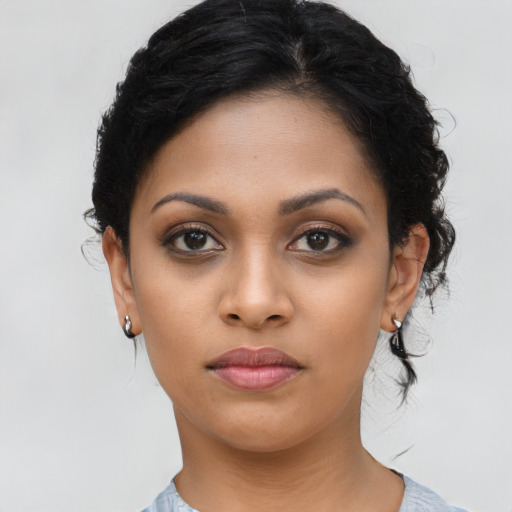 Joyful latino young-adult female with medium  black hair and brown eyes