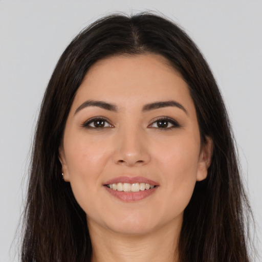 Joyful white young-adult female with long  brown hair and brown eyes