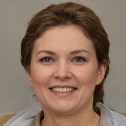 Joyful white adult female with short  brown hair and brown eyes