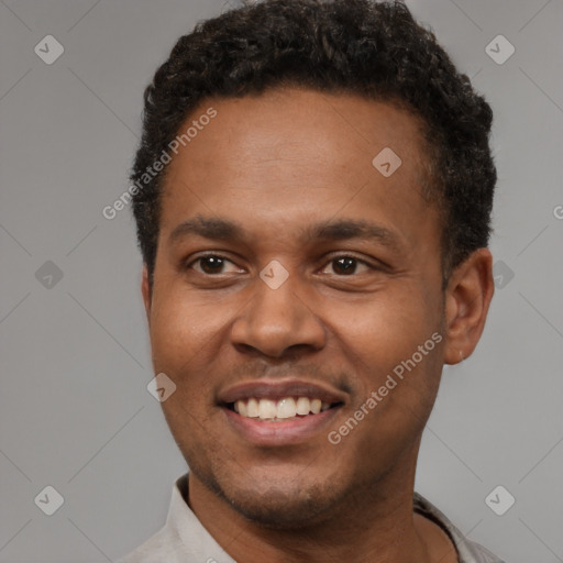 Joyful latino young-adult male with short  black hair and brown eyes