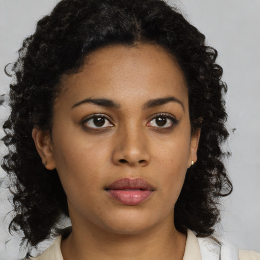 Neutral black young-adult female with medium  brown hair and brown eyes