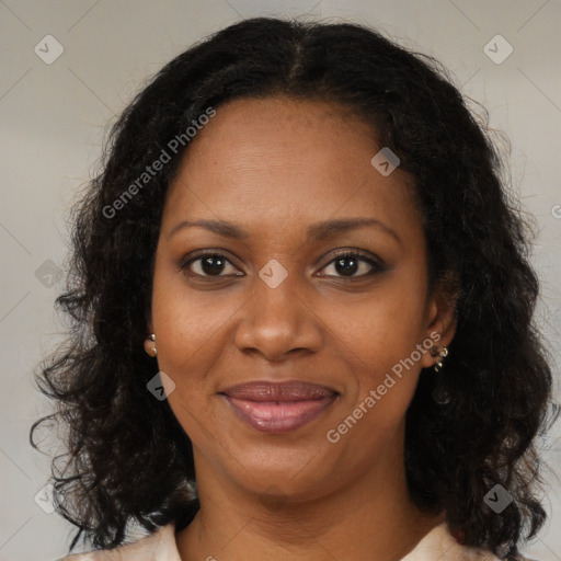 Joyful black adult female with long  brown hair and brown eyes