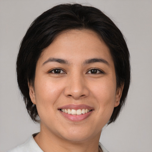 Joyful asian young-adult female with medium  brown hair and brown eyes
