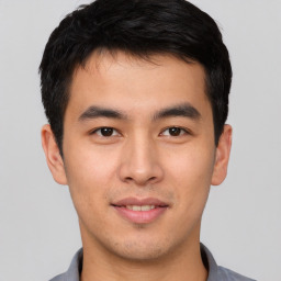 Joyful asian young-adult male with short  brown hair and brown eyes