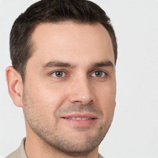 Joyful white young-adult male with short  brown hair and brown eyes