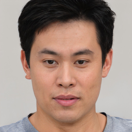 Neutral asian young-adult male with short  brown hair and brown eyes