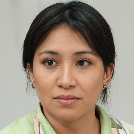 Joyful asian young-adult female with medium  brown hair and brown eyes