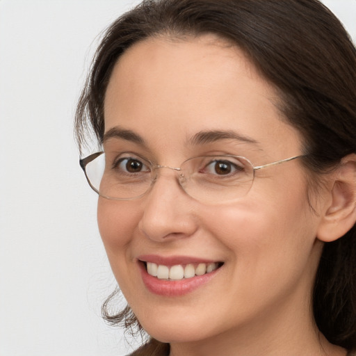 Joyful white adult female with long  brown hair and brown eyes