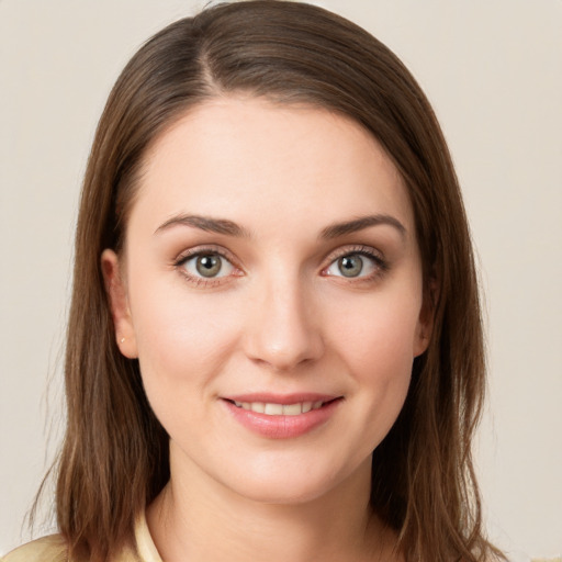 Joyful white young-adult female with medium  brown hair and green eyes