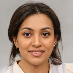 Joyful latino young-adult female with medium  brown hair and brown eyes