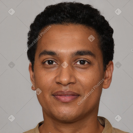 Joyful black young-adult male with short  black hair and brown eyes