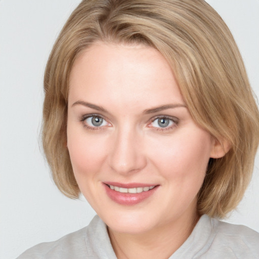 Joyful white young-adult female with medium  brown hair and blue eyes