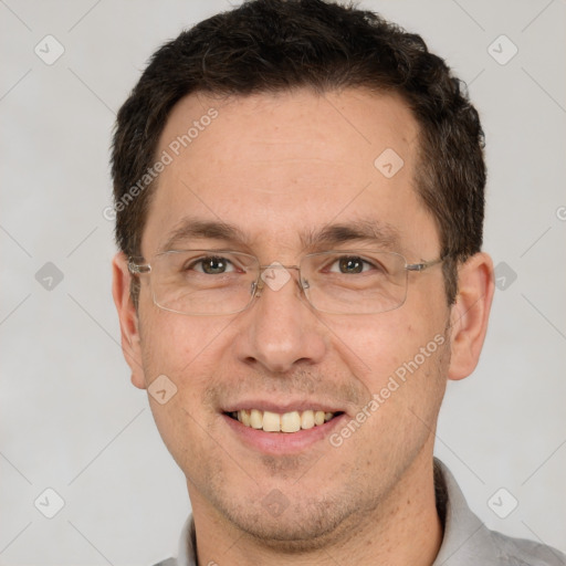 Joyful white adult male with short  brown hair and brown eyes