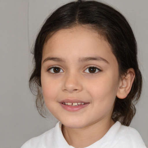 Joyful white child female with medium  brown hair and brown eyes