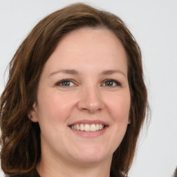 Joyful white young-adult female with medium  brown hair and grey eyes