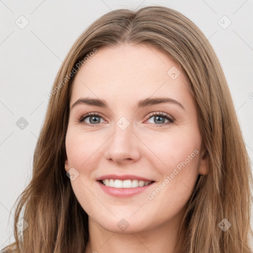 Joyful white young-adult female with long  brown hair and green eyes