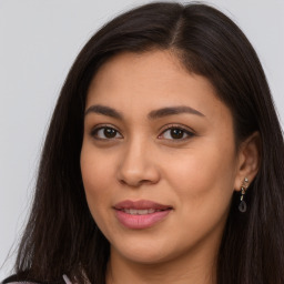 Joyful latino young-adult female with long  brown hair and brown eyes