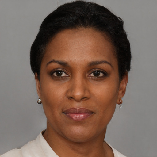 Joyful black young-adult female with short  brown hair and brown eyes