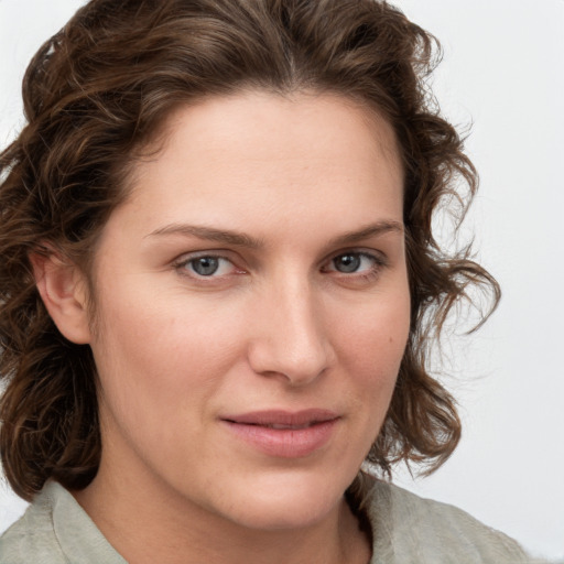 Joyful white young-adult female with medium  brown hair and green eyes