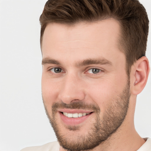 Joyful white young-adult male with short  brown hair and brown eyes