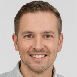 Joyful white adult male with short  brown hair and brown eyes