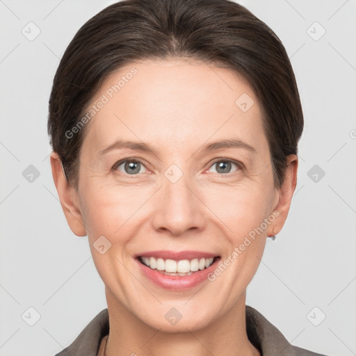 Joyful white adult female with short  brown hair and grey eyes