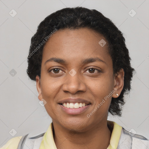 Joyful black young-adult female with short  black hair and brown eyes