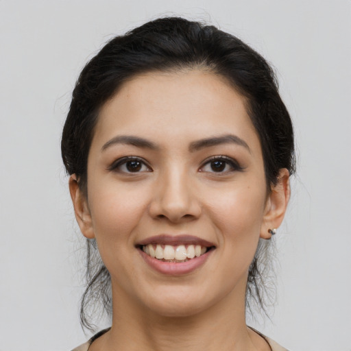 Joyful latino young-adult female with long  brown hair and brown eyes