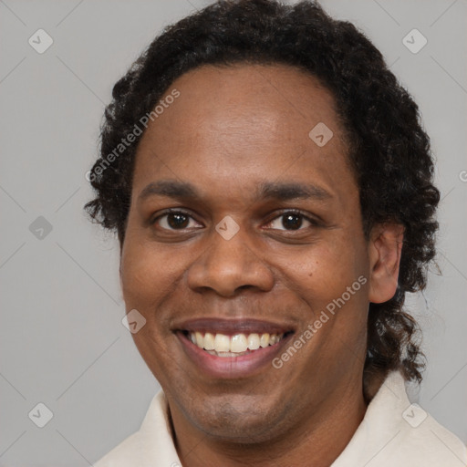 Joyful black young-adult male with short  brown hair and brown eyes