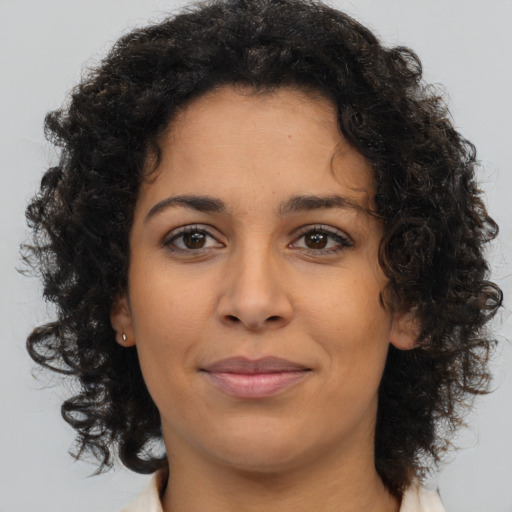 Joyful latino young-adult female with medium  brown hair and brown eyes